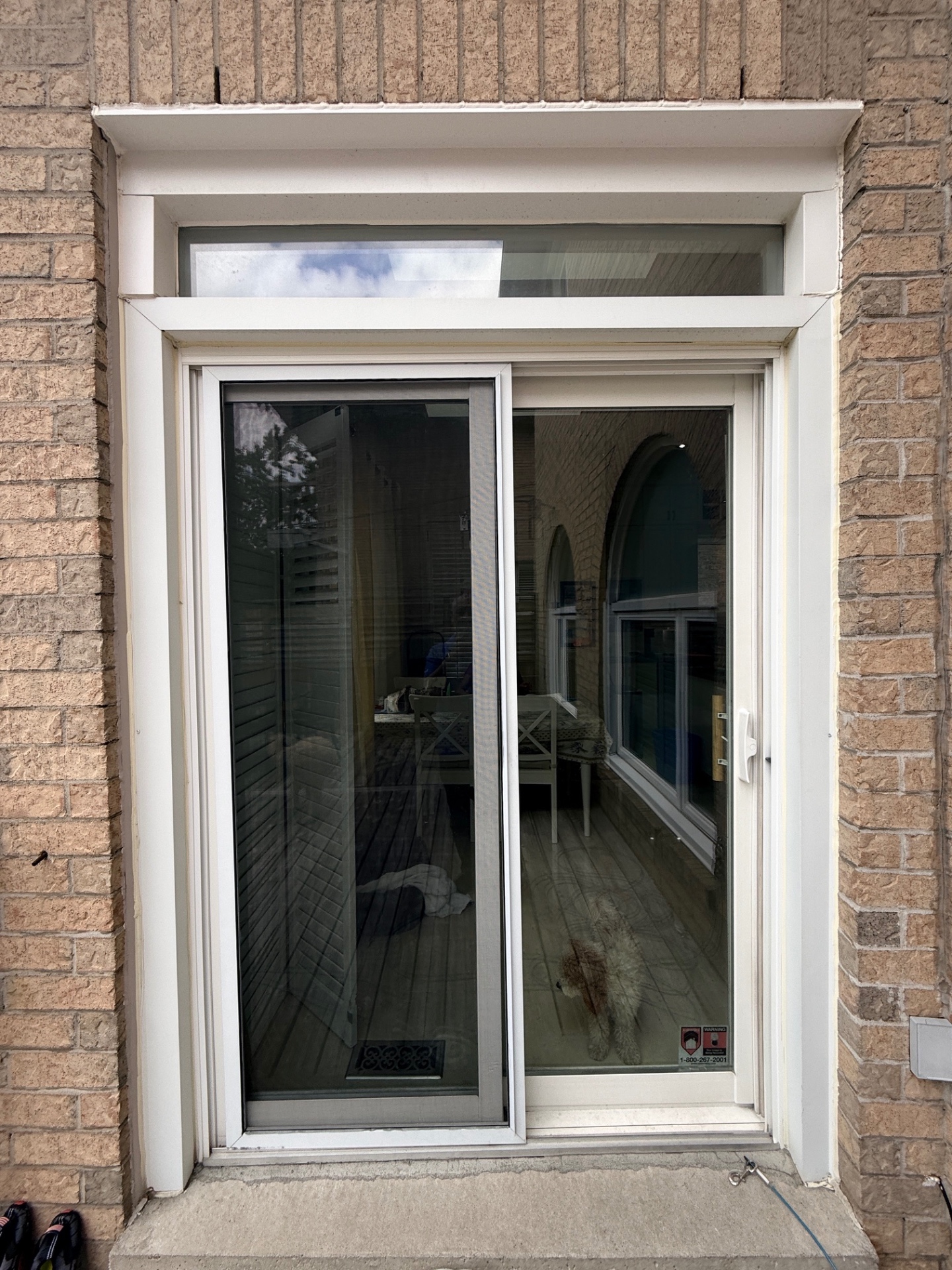 Exterior before view of the old sliding patio door at a North York home