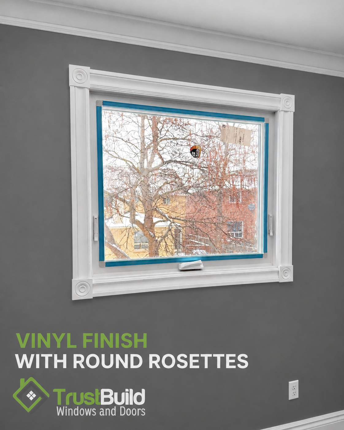 Vinyl window casing with round rosette blocks at each corner, white finish on a grey wall, Ontario home interior