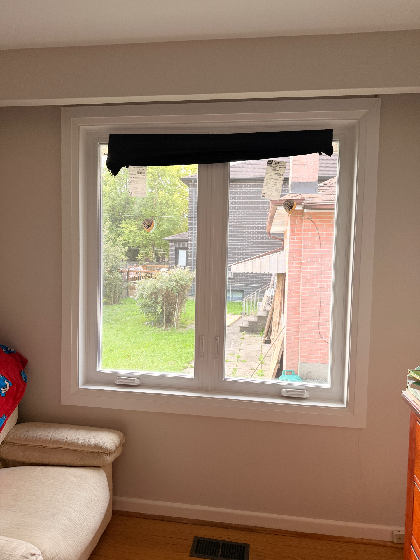 After photo of triple-pane double casement windows in North York, with roto handle hardware, a proper wood ledge, and stepped casing trim