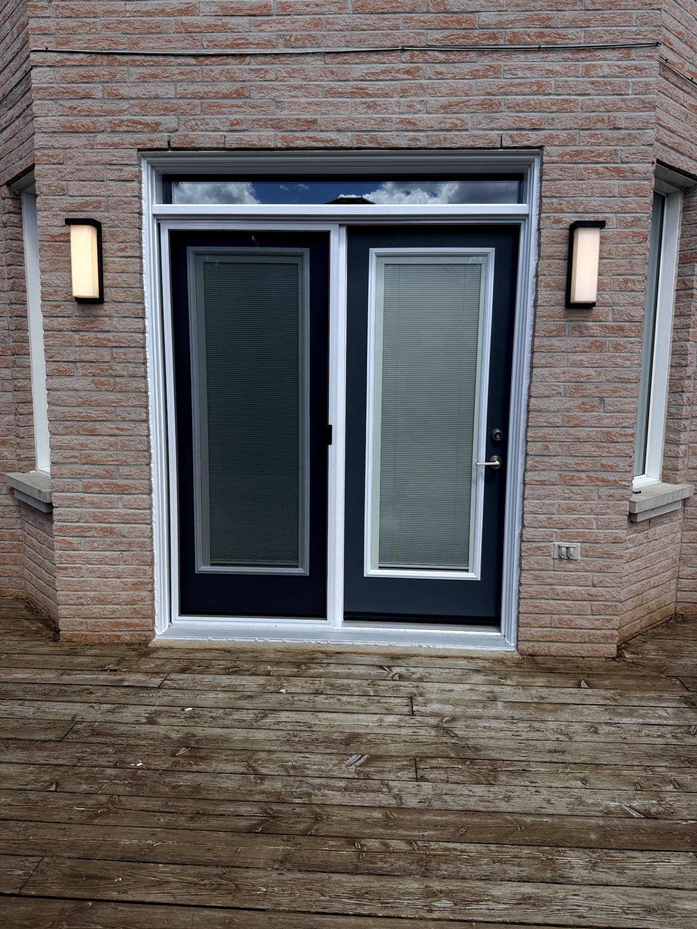 Trust Build French garden door installed in a Whitby home, with a transom above and matching flanking glass in one continuous wall opening