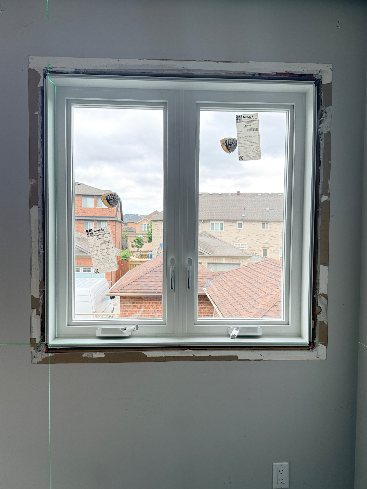 Hybrid split frame window installation showing preserved interior wood trim around a newly installed casement window