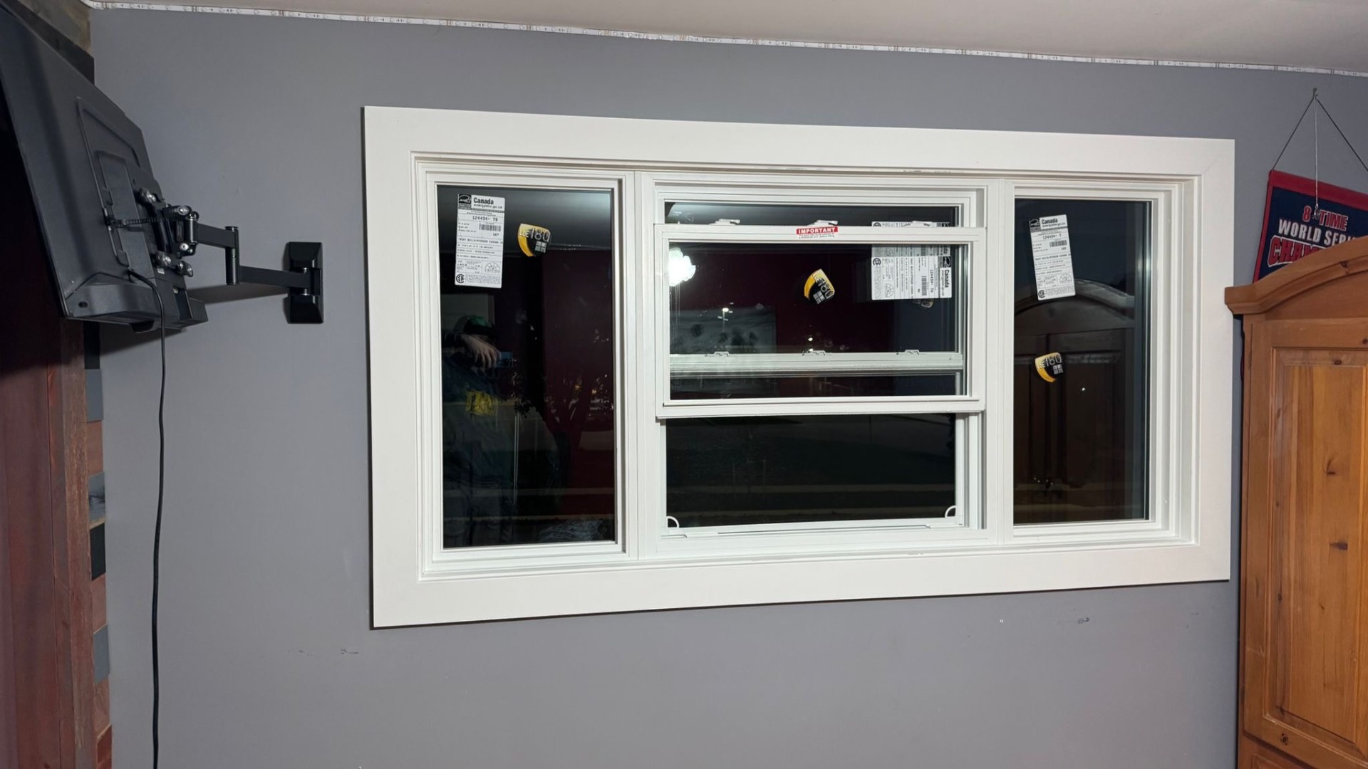 Newly installed white triple-unit interior window with ENERGY STAR certification labels