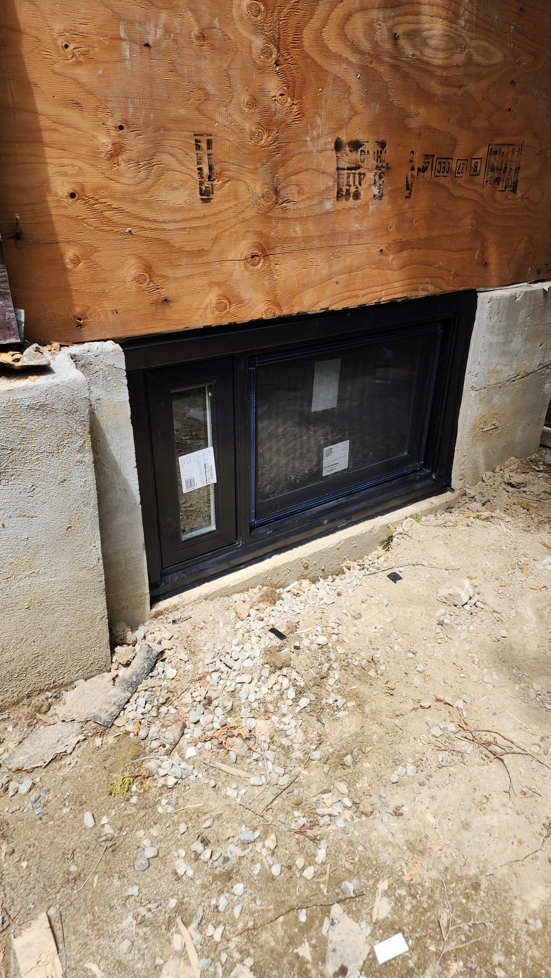 Rotted wood basement window frame being removed during a full-frame replacement in Vaughan